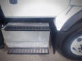 A 2016 International WorkStar 7500 truck showcasing its side step and storage box beneath the driver's door