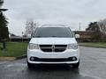 A white 2017 Dodge Grand Caravan parked with a small black grille and distinctive front headlights