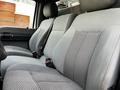 Interior view of a 2016 Ford F-550 showing gray fabric seats with a textured pattern and seatbelts fastened on the front bench seat