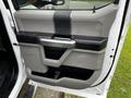 2017 Ford F-550 door panel featuring a modern design with a combination of textured grey and black surfaces and a built-in storage compartment
