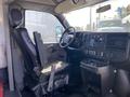 Interior view of a 2017 Chevrolet Express showing the driver's seat and dashboard with controls and a steering wheel