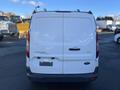 A white 2017 Ford Transit Connect van viewed from the rear with the model name and trim level XLT displayed on the back door