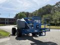 A blue 2012 Genie Z 45/25 boom lift with large wheels and an extended platform raised at an angle