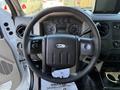Steering wheel and dashboard of a 2009 Ford F-550 featuring gauges and controls