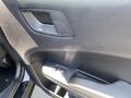 Close-up of the driver door panel of a 2019 Dodge Charger showing the door handle and window control buttons