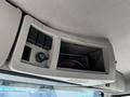 The interior overhead console of a 2005 Volvo VND 122 featuring button switches and a storage compartment