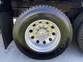 Close-up of a tire mounted on a 2012 Freightliner M2 112 with a shiny alloy wheel and visible tread pattern