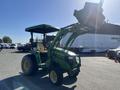 A 2008 John Deere 3320 tractor with a 300X loader attachment featuring a green body and yellow accents