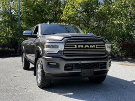 A 2022 RAM 3500 pickup truck with a distinctive grille and rugged tires, showcasing a robust design and front profile aimed at heavy-duty performance
