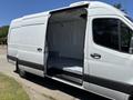 A 2019 Mercedes-Benz Sprinter van with an open sliding door showcasing the empty interior space