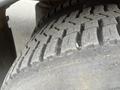 Close-up of a heavily treaded tire from a 2007 Freightliner B2 showing wear and dirt on the rubber surface