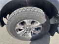 Close-up of a 2014 Ford F-150 wheel with a Toyo AT tire showing tread pattern and alloy rim