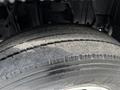Close-up of a worn tire on a 2015 Mitsubishi Fuso FE showing visible tread depth and wear patterns