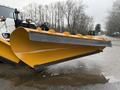 A 2016 Freightliner 108SD equipped with a large yellow snow plow blade angled forward