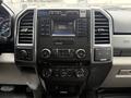 Dashboard of a 2018 Ford F-550 featuring a radio display control panel with various buttons and knobs for audio and climate settings