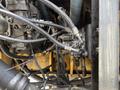 Close-up of the hydraulic system components of a 2018 John Deere 350 including various hoses and metal fittings