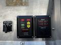 Control panel of a 2006 Emergency One Fire Truck featuring buttons for idle, preset, mode, and pressure along with gauges for engine and pump status