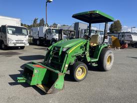 A 2008 John Deere 3320 tractor with a 300X loader features a green body and a black canopy designed for agricultural tasks