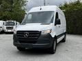 A 2020 Mercedes-Benz Sprinter van with a white exterior and black front grille parked on gravel