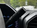 A close-up of the multifunction steering wheel control lever in a 2020 Ford F-350 SD featuring buttons for cruise control and mode selection