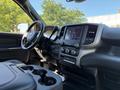 Interior of a 2022 RAM 5500 featuring a modern dashboard with touchscreen controls and cup holders