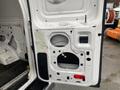 A disassembled door panel from a 2011 Ford Econoline showing internal components and cutouts without any outer covering or finishing