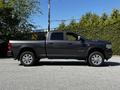 A gray 2022 RAM 3500 pickup truck is shown from the side with a tall body and large wheels