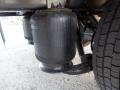 The image shows the suspension system of a 2014 International Durastar featuring air springs designed for enhanced load support and ride comfort