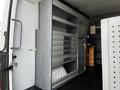 A 2017 Mercedes-Benz Sprinter van interior featuring organized metal storage shelves and drawers for tools and equipment