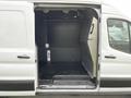 Interior of a 2020 Ford Transit cargo van showing a spacious empty cargo area with a black floor and side walls