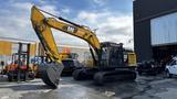 A 2018 Caterpillar 326F L Excavator with a yellow and black color scheme featuring a large front bucket and tracked chassis positioned on a concrete surface