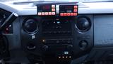 Interior dashboard of a 2011 Ford F-550 featuring various controls including audio system buttons and knobs