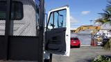 A white 2015 International 7400 truck with its driver's side door open showcasing the interior door panel