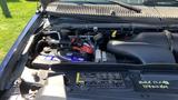 Engine compartment of a 2013 Ford Econoline showing the battery air intake and various components