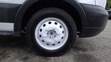 Close-up of a white wheel with a circular pattern and silver bolt holes from a 2018 Ford Transit van