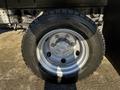 Close-up of a silver wheel with a Bridgestone tire mounted on a 2014 Mitsubishi Fuso FE truck