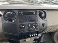 Dashboard of a 2010 Ford F-250 SD featuring climate controls radio display and various buttons and knobs
