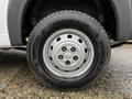 A close-up view of a silver wheel with five exposed lug nuts and a black tire labelled Nexen with a tread pattern visible