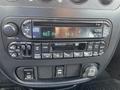 Dashboard of a 2005 Chrysler PT Cruiser featuring a radio and CD player with various control buttons and knobs