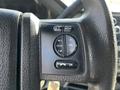 Steering wheel controls of a 2016 Ford F-550 with buttons for media, volume, seek, and an ok selection