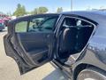 A 2019 Dodge Charger with the rear door open showing the interior seating and door panel details