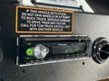 A Pioneer car stereo displaying the time 12:17 PM with a prominent volume knob and buttons for other functions