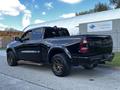 A black 2019 RAM 1500 pickup truck positioned at an angle showing its glossy exterior and rugged wheels