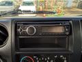 Interior view of a 2014 Hino 195 dashboard featuring a car stereo with Bluetooth capability and climate control dials below
