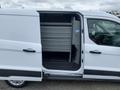 A 2017 Ford Transit Connect van with an open side door revealing interior storage shelves