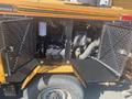 A 2010 Trackless MT6 with open engine compartments revealing mechanical components and a yellow and black exterior