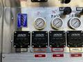 Control panel of a 2006 Emergency One Fire Truck featuring gauges and switches for water level tank fill and pump functions