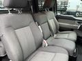 Interior view of a 2010 Ford F-150 featuring gray upholstered seating with two rows of seats and armrests