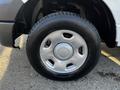 A close-up of a silver wheel and tire from a 2008 Ford F-150 XL showing the tread and rim design