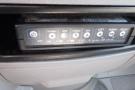 Control panel with various buttons and switches for functions like enable dim cargo and aux in a 2012 Mercedes-Benz Sprinter
